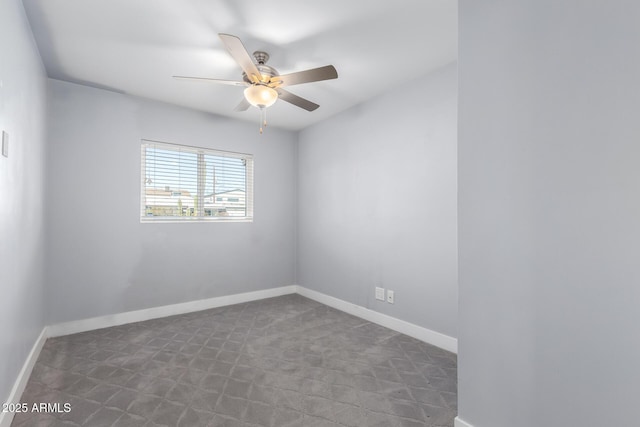 spare room with ceiling fan and dark colored carpet