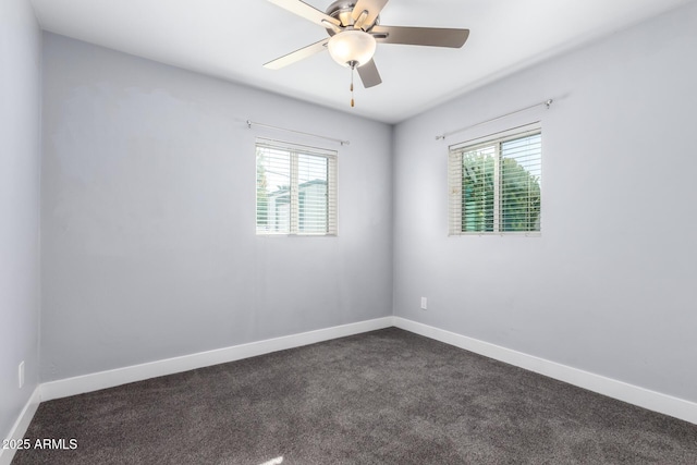 unfurnished room featuring ceiling fan and dark colored carpet