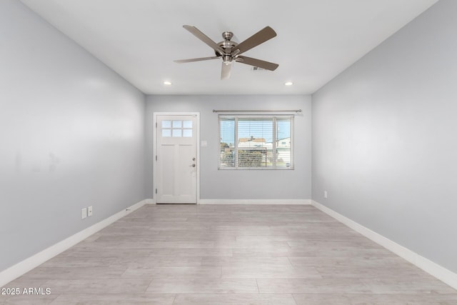 foyer with ceiling fan and light wood-type flooring