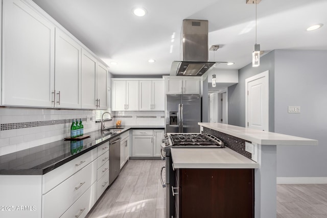 kitchen with white cabinetry, island range hood, a center island, hanging light fixtures, and appliances with stainless steel finishes