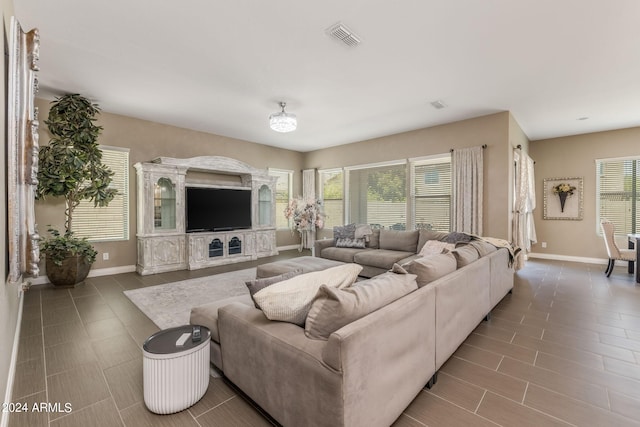 living room with tile patterned flooring and plenty of natural light