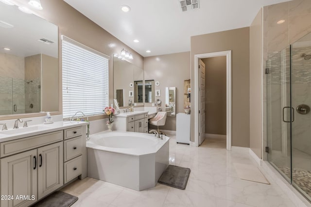 bathroom featuring vanity, a healthy amount of sunlight, and plus walk in shower