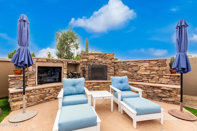 view of patio with an outdoor stone fireplace