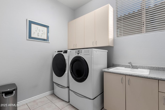 laundry room featuring cabinets, light tile patterned flooring, independent washer and dryer, and sink