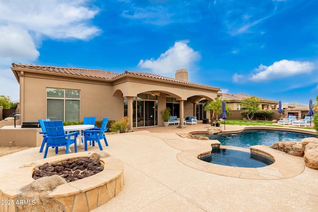 view of pool featuring ceiling fan, a patio area, and an in ground hot tub