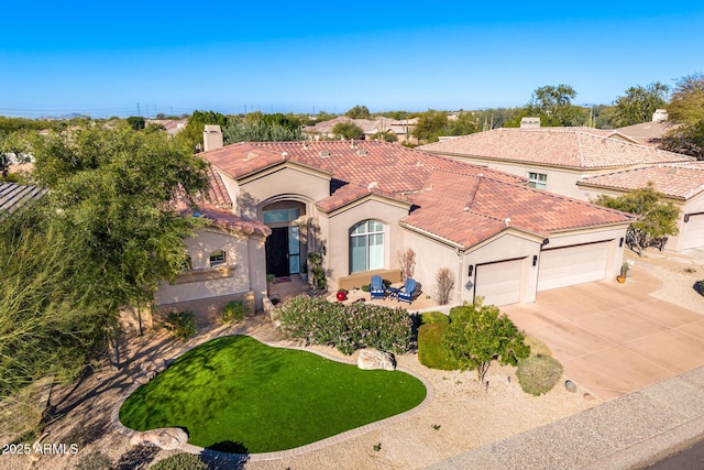 mediterranean / spanish home featuring a garage