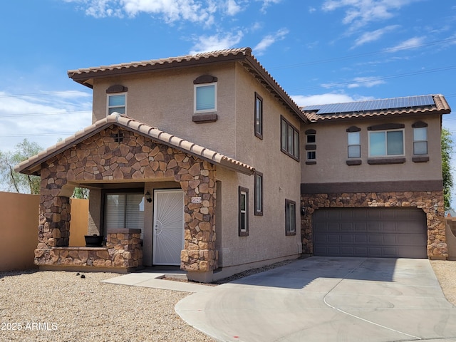 6620 W Shaw Butte Dr, Glendale, AZ 85304 - mediterranean / spanish-style home with stone siding, a tiled roof, stucco siding, driveway, and roof mounted solar panels