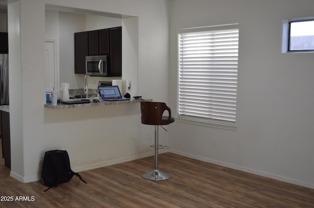 6620 W Shaw Butte Dr, Glendale, AZ 85304 - kitchen with stainless steel microwave, dark wood-type flooring, and baseboards
