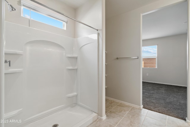 bathroom featuring walk in shower and tile patterned flooring