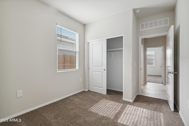 unfurnished bedroom with carpet and a closet