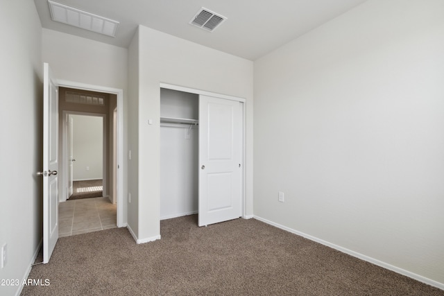 unfurnished bedroom featuring a closet and carpet flooring