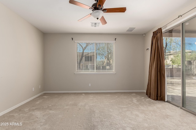 unfurnished room featuring plenty of natural light, light colored carpet, and ceiling fan