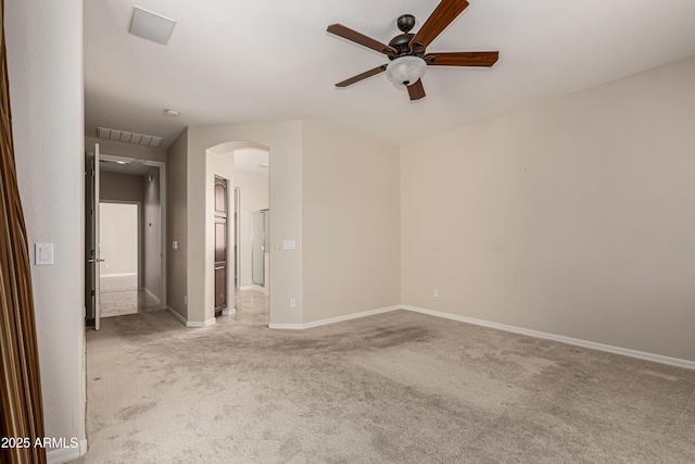 spare room featuring light colored carpet and ceiling fan