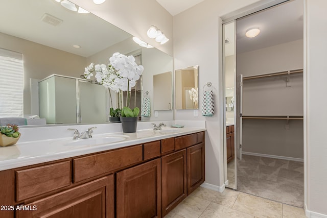 bathroom featuring vanity, tile patterned floors, and a shower with shower door