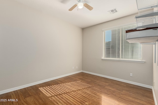 spare room featuring wood-type flooring and ceiling fan