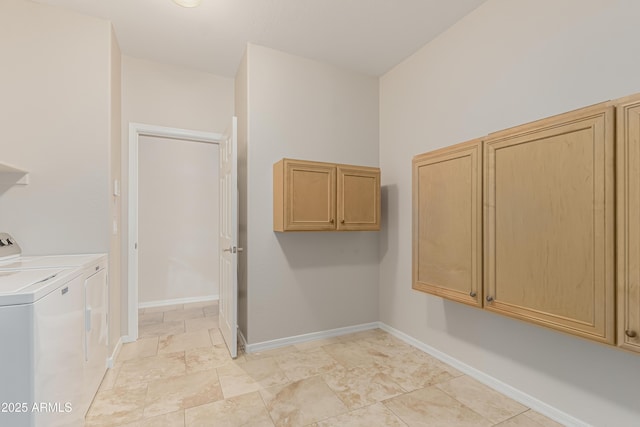 laundry area featuring separate washer and dryer and cabinets