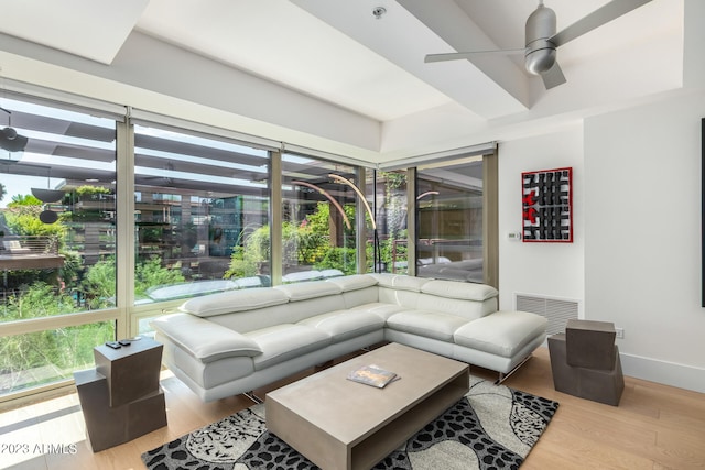 living room with ceiling fan and light wood-type flooring