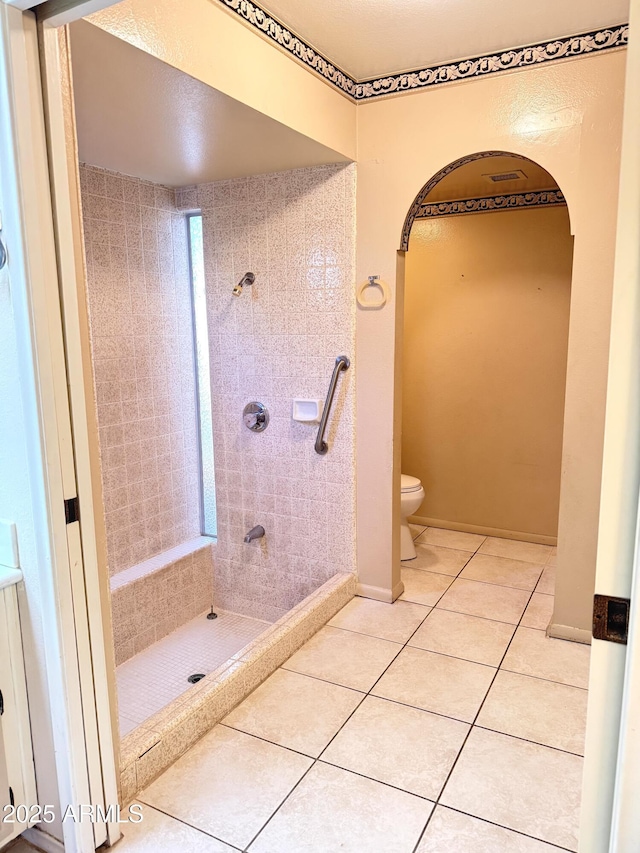 8552 E Via Del Palacio, Scottsdale, AZ 85258 - full bathroom featuring tile patterned flooring, a tile shower, and toilet
