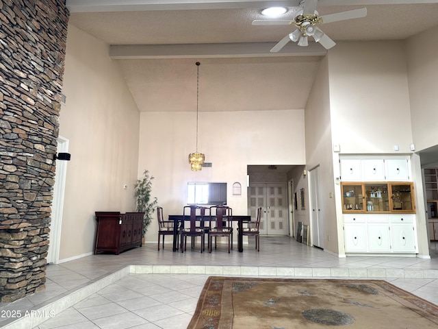 8552 E Via Del Palacio, Scottsdale, AZ 85258 - tiled dining room with high vaulted ceiling, ceiling fan, beamed ceiling, baseboards, and inlaid floor details