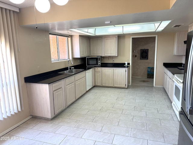 8552 E Via Del Palacio, Scottsdale, AZ 85258 - kitchen featuring black microwave, dark countertops, baseboards, white dishwasher, and a sink