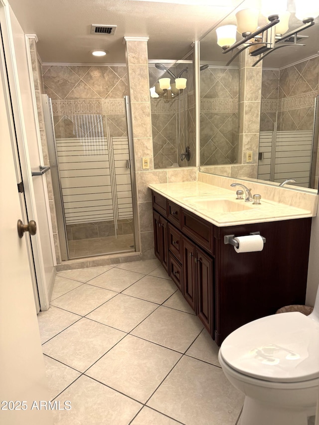 8552 E Via Del Palacio, Scottsdale, AZ 85258 - bathroom featuring visible vents, vanity, tile patterned floors, a stall shower, and a notable chandelier