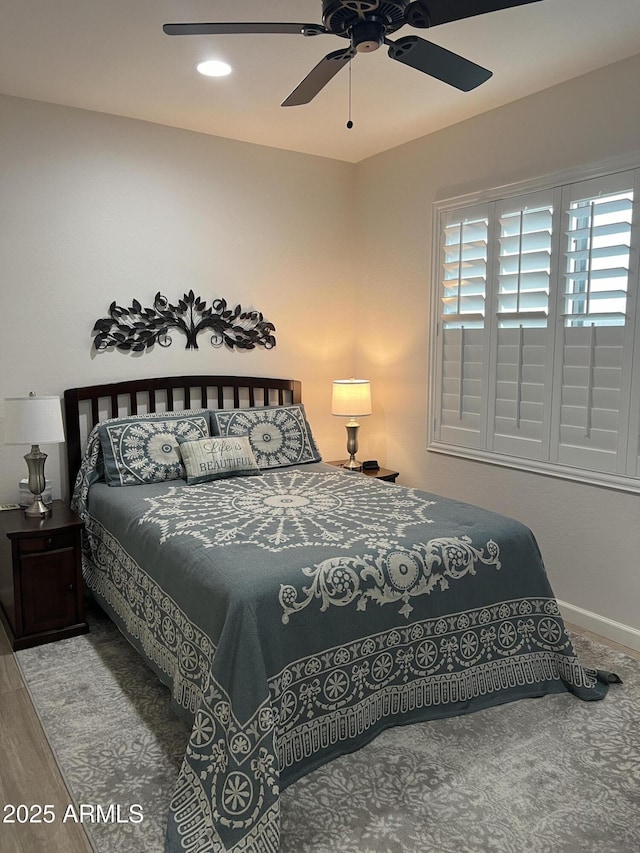 bedroom with hardwood / wood-style floors and ceiling fan