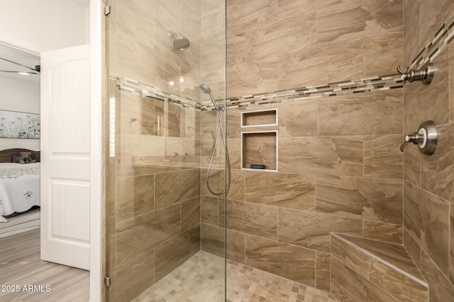 bathroom featuring a tile shower and hardwood / wood-style floors