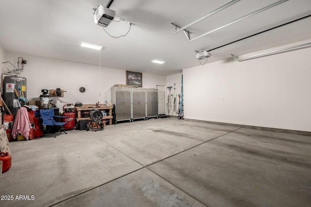 garage featuring a garage door opener and electric water heater