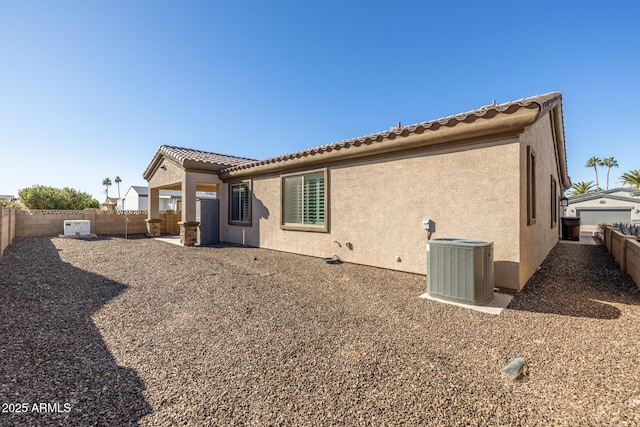 back of house featuring central air condition unit and a patio