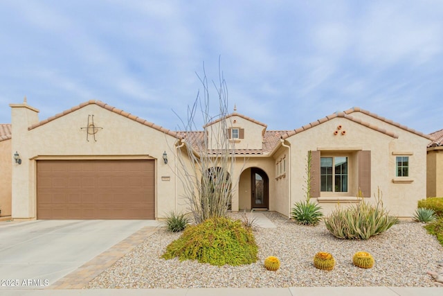 mediterranean / spanish-style house featuring a garage