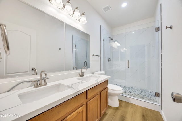 bathroom with vanity, wood-type flooring, an enclosed shower, and toilet