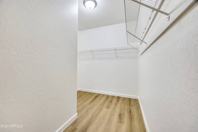 spacious closet featuring hardwood / wood-style floors