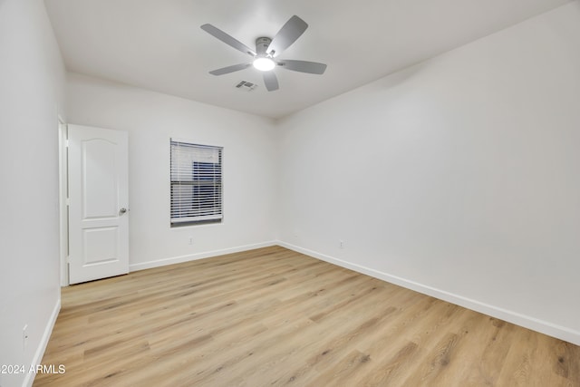 spare room featuring ceiling fan and light hardwood / wood-style flooring