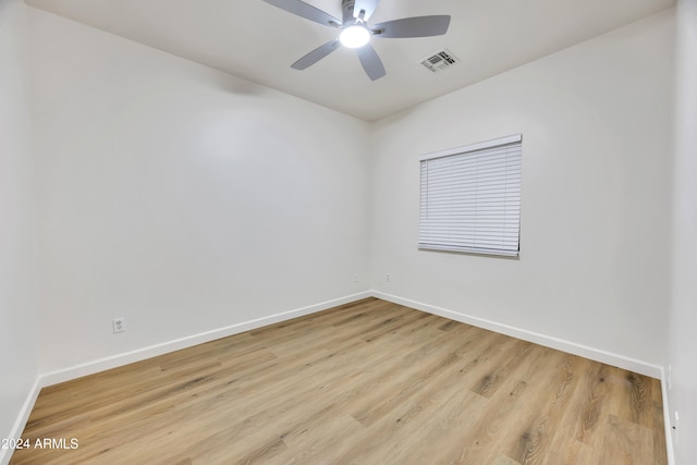 empty room featuring light hardwood / wood-style flooring and ceiling fan