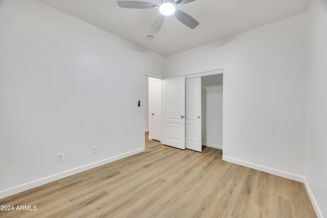 unfurnished bedroom with ceiling fan, a closet, and light hardwood / wood-style floors