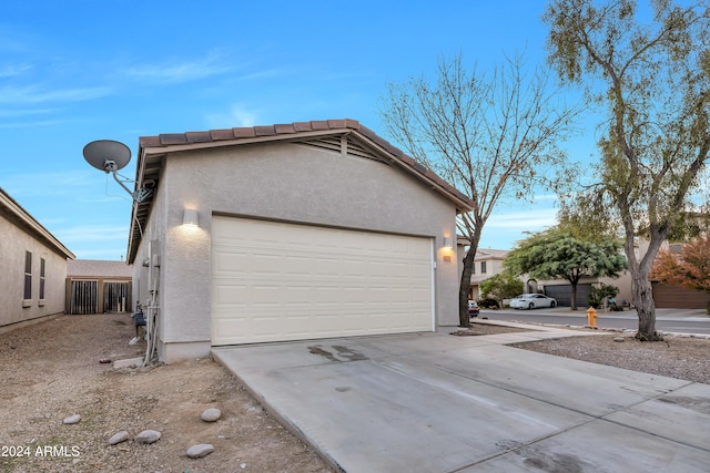 view of side of home featuring a garage