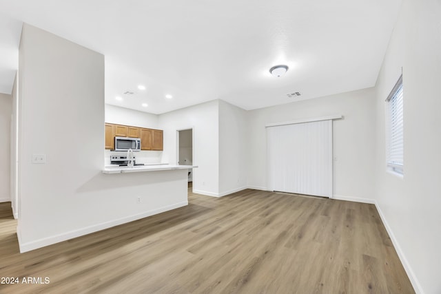 unfurnished living room with light hardwood / wood-style flooring