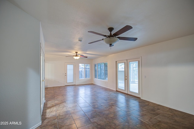 unfurnished room with french doors and ceiling fan