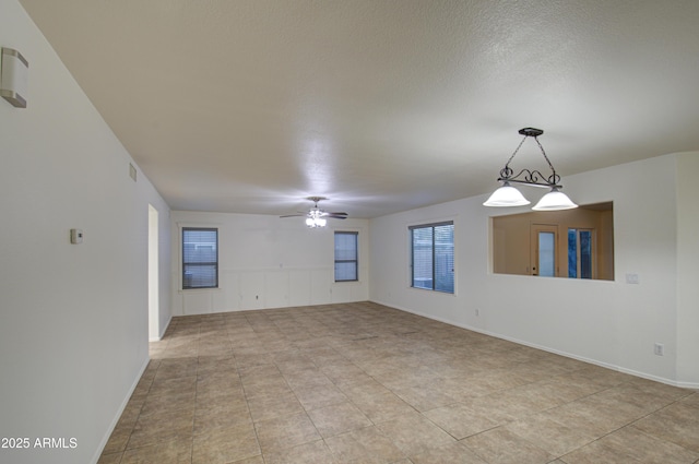 spare room with ceiling fan and a textured ceiling