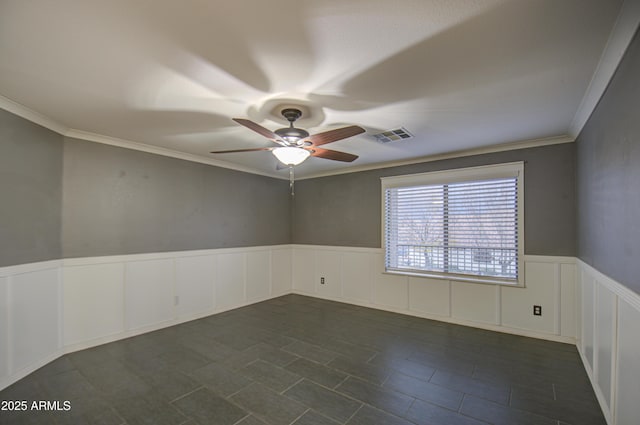 spare room with ceiling fan and ornamental molding