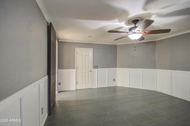 spare room with crown molding and ceiling fan