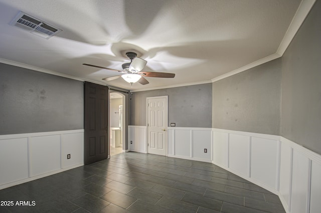 unfurnished room with crown molding and ceiling fan