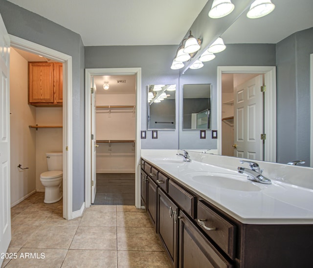 bathroom featuring vanity, tile patterned floors, and toilet