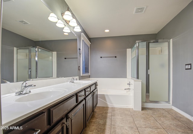 bathroom with tile patterned flooring, vanity, and separate shower and tub