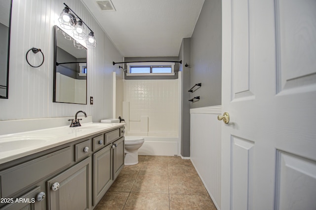 full bathroom with wood walls, bathtub / shower combination, vanity, toilet, and tile patterned floors