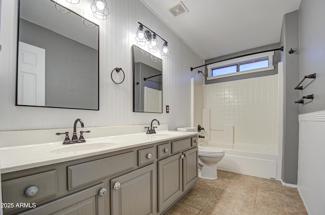 full bathroom with toilet, wood walls, shower / bathing tub combination, vanity, and tile patterned flooring