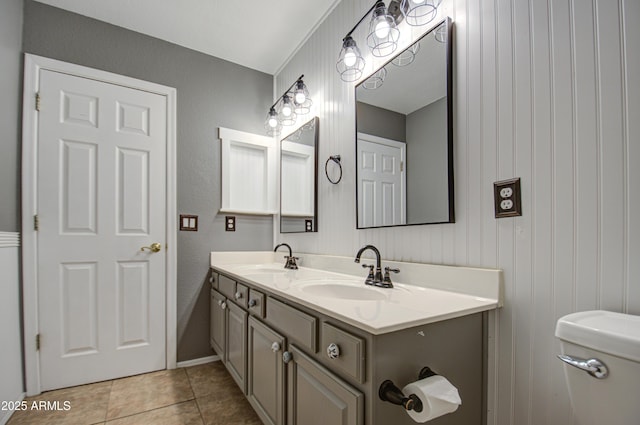 bathroom with tile patterned flooring, vanity, and toilet