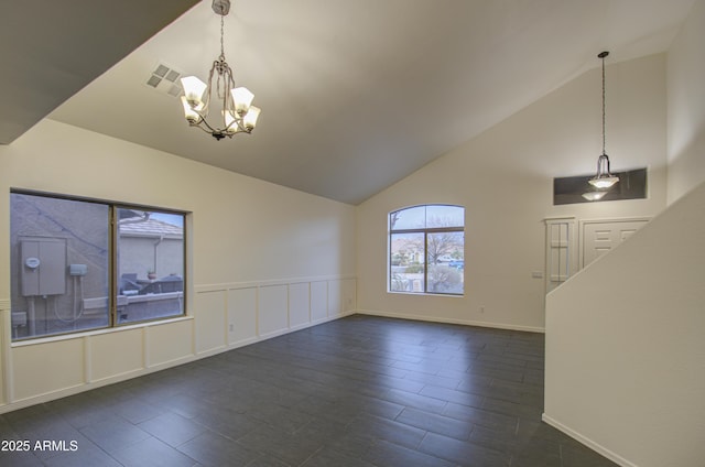 unfurnished living room with vaulted ceiling and a notable chandelier