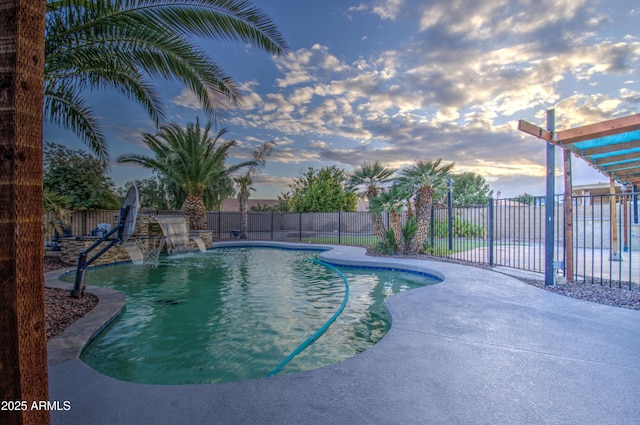 pool at dusk featuring a patio and pool water feature