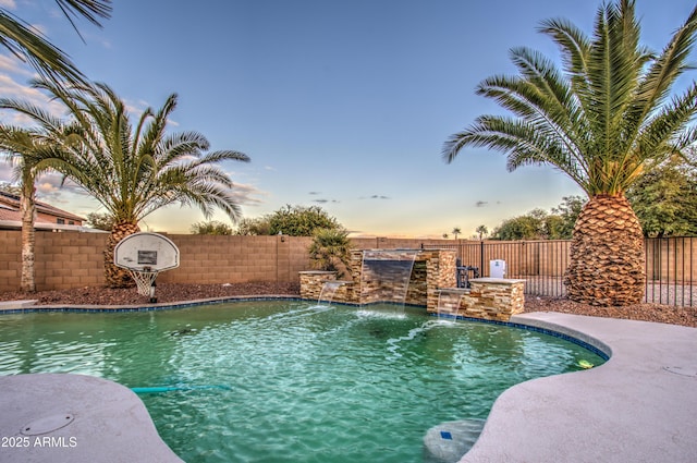 pool at dusk with pool water feature